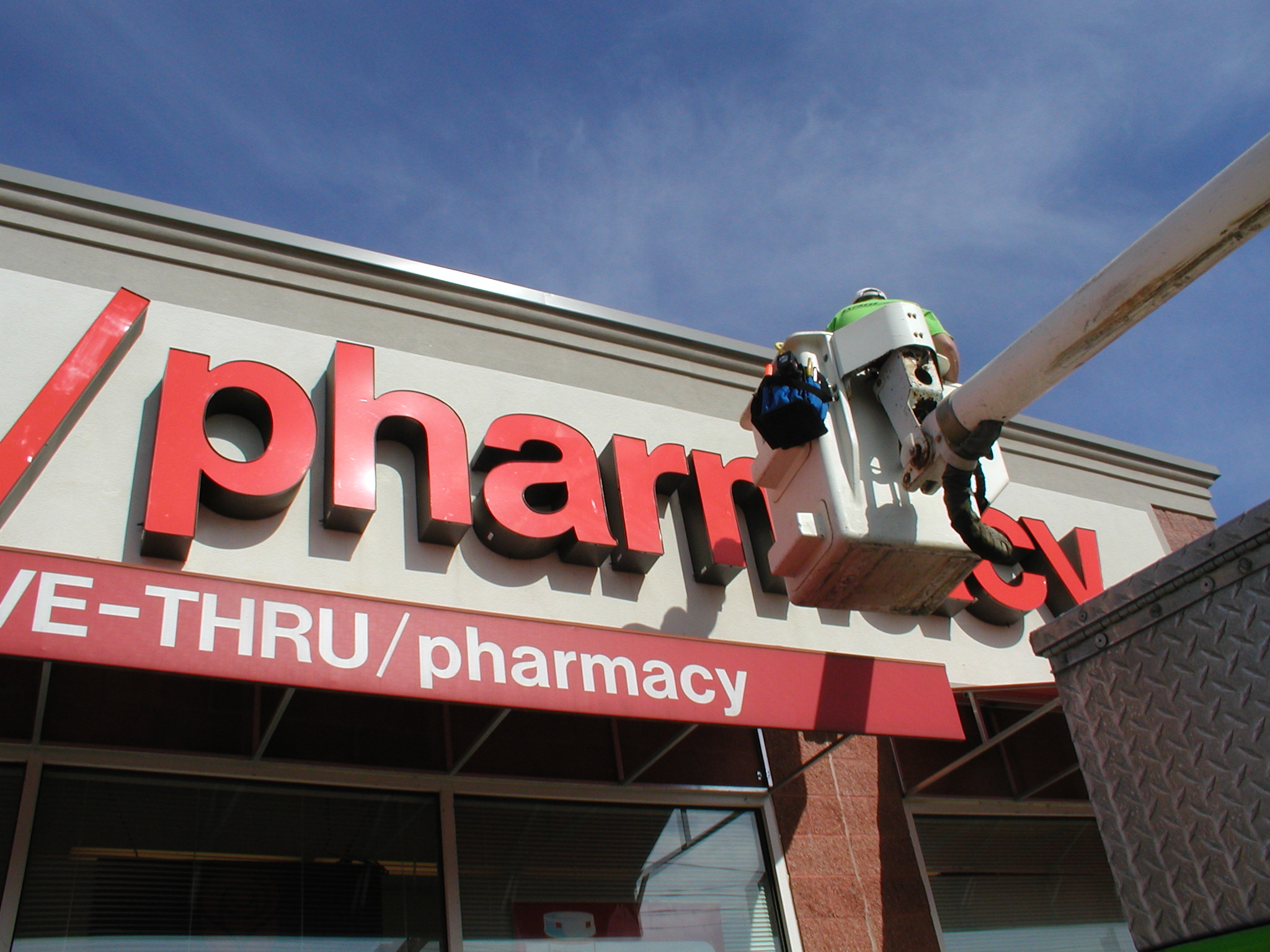 Electrician repairing sign